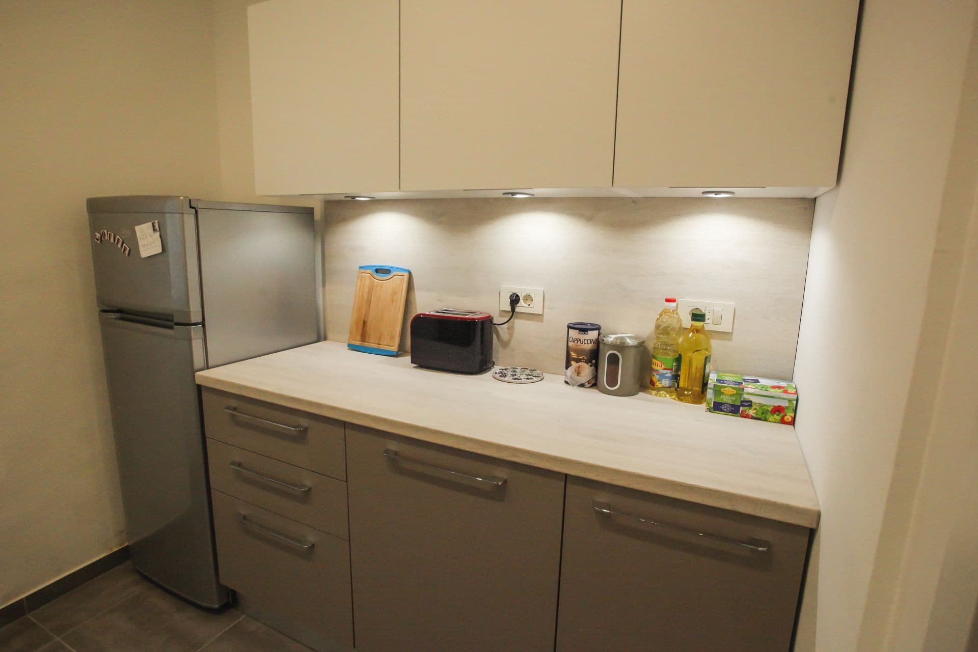 Open plan living space connecting kitchen, dining, and relaxation areas